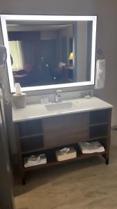 a bathroom with a sink and a large mirror at Baymont by Wyndham Culpeper in Culpeper