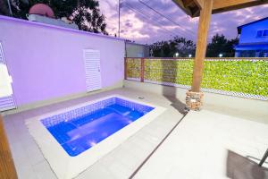 a swimming pool on a patio with a fence at Sky Blue in Jarabacoa