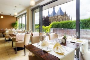 a restaurant with tables and chairs and a view of a building at Penzion a Restaurant Barbora in Kutná Hora