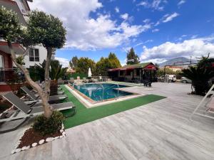un patio con piscina y una casa en kerim apart tatil evleri, en Fethiye