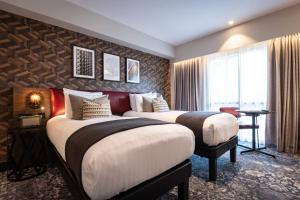 En eller flere senge i et værelse på voco Leicester, an IHG Hotel