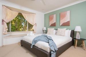 a bedroom with a large bed and a window at Waterfront Retreat with Private Dock-Isle of Capri in Gold Coast