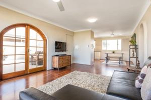 a living room with a couch and a table at Inner City Pad - Indooroopilly in Brisbane