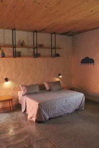 a bedroom with a bed and shelves on the wall at Villa dos Pireneus in Pirenópolis