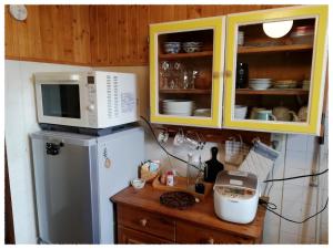 a kitchen with a microwave and a refrigerator at Eniwa - House / Vacation STAY 5059 in Eniwa