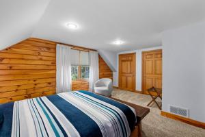 - une chambre avec un lit et un mur en bois dans l'établissement Private Lakefront! - Luxury Log House!, à Sanbornton