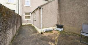 an empty alley next to a building at Cumberland House-2 Bed House in Workington