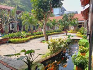 a garden with a koi pond in a courtyard at Ninh Binh Mountain Side Homestay & Cafe in Ninh Binh