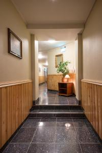 a hallway with a potted plant in a room at Tino's Hotel in Namsos