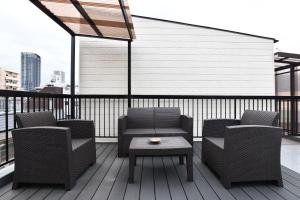 a patio with chairs and a table on a balcony at FL House Naniwacho - Vacation STAY 13598 in Osaka
