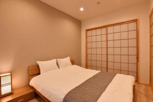 a bedroom with a large white bed and a japan at FL House Naniwacho - Vacation STAY 13598 in Osaka