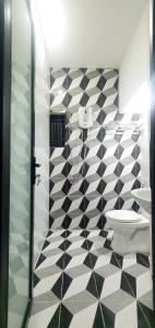 a bathroom with a black and white tiled wall at Villa 68 4BR FREE PICK-UP AIRPORT & BILLIARDS CLOSE TO MY KHE BEACH in Da Nang