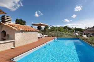 a villa with a swimming pool and a wooden deck at A Casa di Franca Villa con piscina in Gambassi Terme
