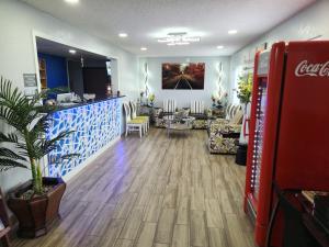 a cocacola store with a coke machine in a room at Express Inn Parsons in Parsons