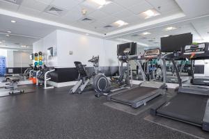 a gym with several treadmills and exercise equipment at Crown New Haven Hotel Penthouse At Yale in New Haven