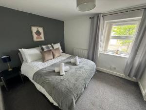 En eller flere senge i et værelse på Woodman House- 7 Bedrooms - Sleeps 14