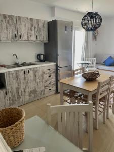 a kitchen and dining room with a table and chairs at Kostas Studios in Faliraki