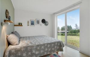 a bedroom with a bed and a large window at Awesome Home In Børkop in Børkop +18 photos