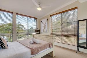 a bedroom with a bed and large windows at Escape To Narrabeen @ Sydney Northern Beaches - Home Away From Home in Narrabeen