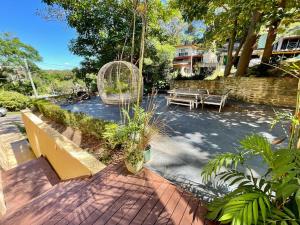 a patio with a bench and a swing at Escape To Narrabeen @ Sydney Northern Beaches - Home Away From Home in Narrabeen