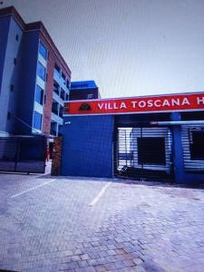 a building with a sign that reads villa toscanza at Villa toscana okpanam Rd Asaba in Okpanam