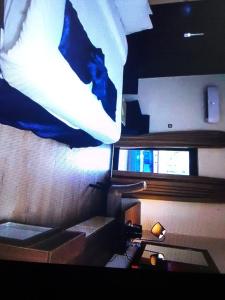 a room with a bed and a light on the wall at Villa toscana okpanam Rd Asaba in Okpanam
