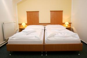 Postel nebo postele na pokoji v ubytování Garni G Hotel Žilina