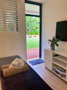 a room with a bed with a towel on the floor at Bayona 1 Little Cove in Noosa Heads