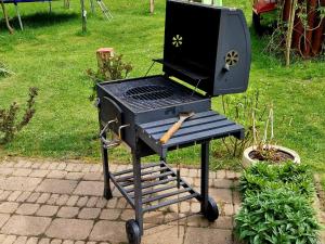 a grill sitting on a table in a yard at Apartmány Petronela in Makov
