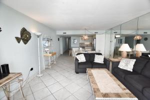 a living room with two couches and a kitchen at 1412 Waters Edge Resort condo in Myrtle Beach