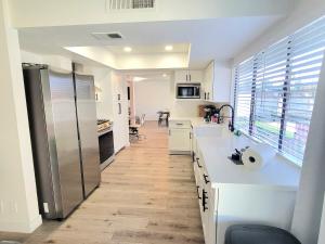 a kitchen with white counters and a stainless steel refrigerator at Vegas best stay in Las Vegas