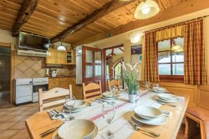 a dining room with a table with plates and wine glasses at Forge of Happiness Rustic Retreat - Happy Rentals in Gradac