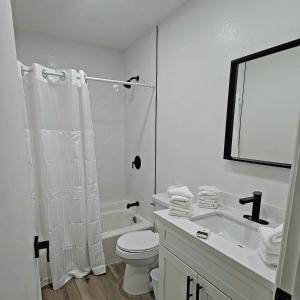 a white bathroom with a toilet and a sink at Vegas best stay in Las Vegas