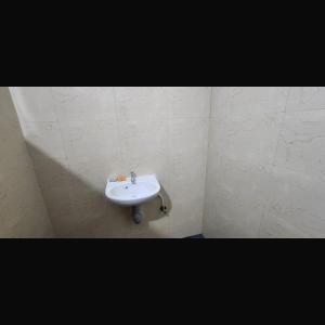 a white sink in the corner of a bathroom at Falcon Jungle Resort in Jyoti Gaon