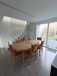 ein Esszimmer mit einem Holztisch und Stühlen in der Unterkunft Holiday Home In Blokhus in Blokhus