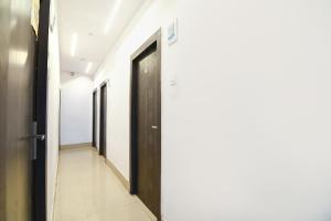 a corridor of a hospital hallway with a door at FabExpress Vhyom Sky Palace in Kolkata