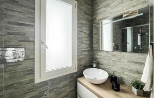 a bathroom with a white sink and a mirror at 1 Bedroom Awesome Home In Leporano in Leporano
