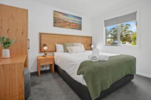 a bedroom with a large bed and a window at Tasman Holiday Parks - St Helens in St Helens
