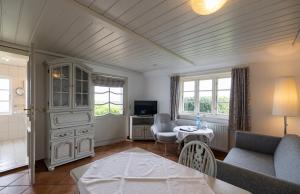 a living room with a couch and a table at Haus Amanda in Norddorf