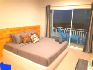 a bedroom with a bed with a view of a balcony at Seasmile kohlarn in Ko Larn