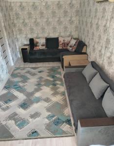 a living room with a couch at Аренда 2-ух комнатная посуточно in Balqash