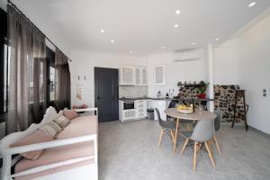 a living room with a couch and a table at Halari Junior Suite in Vourvoúlos