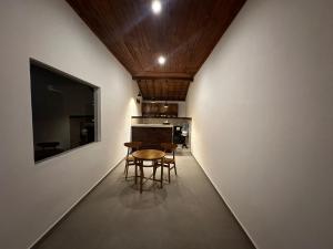 a kitchen with white walls and a table and chairs at Onang Aning Villa Ubud in Ubud