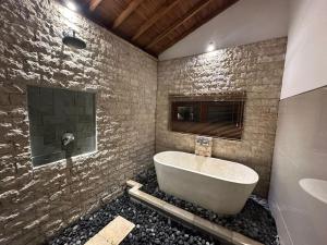 a bathroom with a tub and a sink at Onang Aning Villa Ubud in Ubud +11 photos