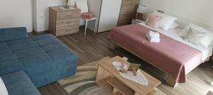 - une chambre avec un lit et un canapé bleu dans l'établissement B&B Buzolic, à Hvar