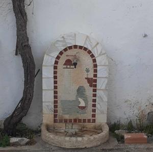 a tile archway in a building with a tree at house FYNTIKAKH - SKALA in Anopoli Sfakion
