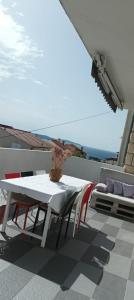 a white table and chairs on a roof at B&B Buzolic in Hvar