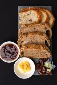 a tray with bread and a plate of jam and other food at Casa Art Ubud in Ubud