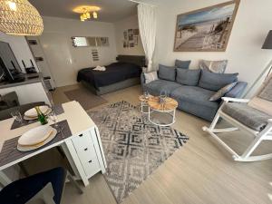 a living room with a couch and a table at Wohnung Südstrand Glück in Fehmarn