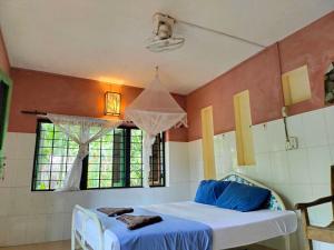 a room with a bed and a window at Jungle House Kep in Kep